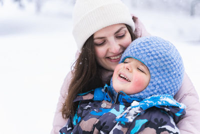 Portrait of a smiling young woman in snow