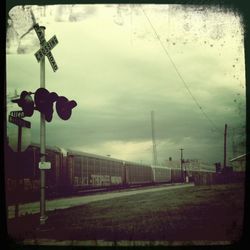 Street light against cloudy sky