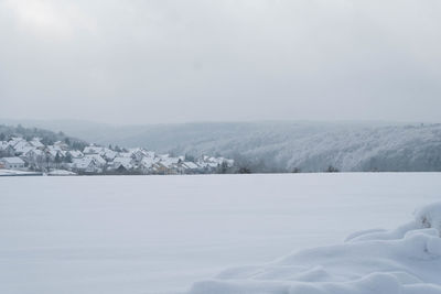 Scenic view of snow covered landscape against sky