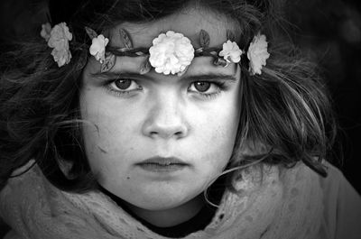 Close-up portrait of girl with flower headband