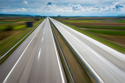 Blurred motion of highway against sky