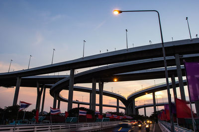 Low angle view of bridge in city against sky