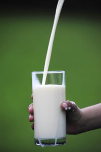 Close-up of hand holding glass of drink