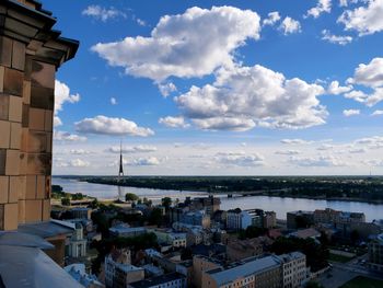 High angle view of buildings in city against cloudy sky