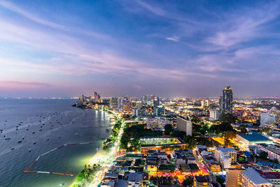 High angle view of buildings by sea against sky