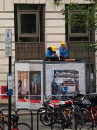 People working on street in city