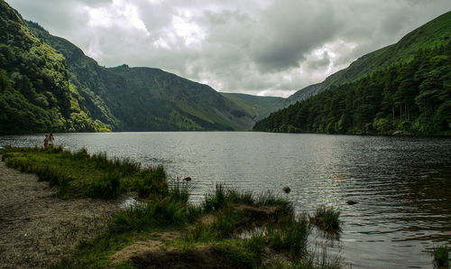 Scenic view of lake against cloudy sky