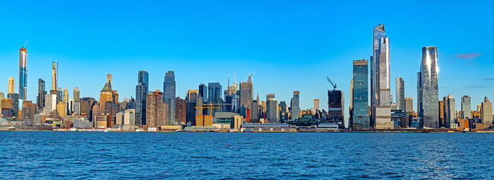 Panoramic view of modern buildings in city against sky