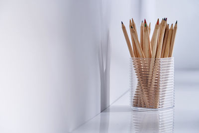 Close-up of pencil on table against white background