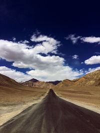 Empty road along barren landscape