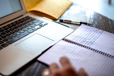 High angle view of laptop and book on table