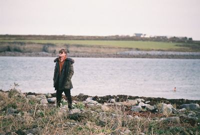 Full length of man standing on beach against sky