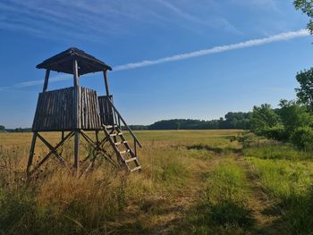 Traditional windmill on field against sky