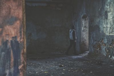 Rear view of woman standing in corridor