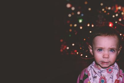 Portrait of cute girl crying at night