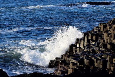 Waves splashing on rocks at shore