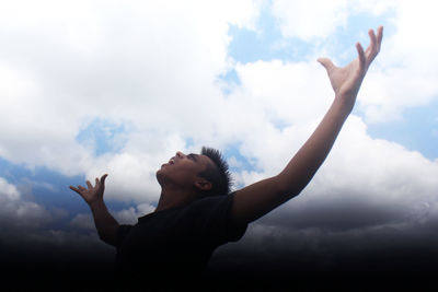 Low angle view of silhouette man against sky