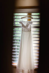 Clothes hanging on window at home