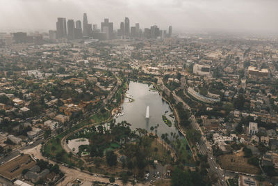 Echo park in los angeles with view of downtown skyline and foggy polluted smog air in big urban city