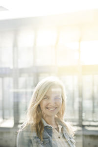 Portrait of smiling young woman seen through glass