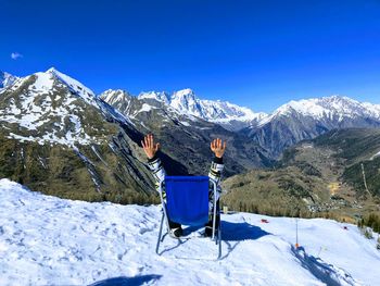 Scenic view of snowcapped mountains against blue sky