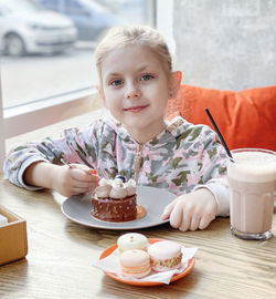 Portrait of boy sitting on table