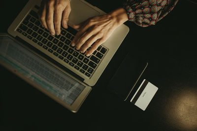 Hands of businesswoman working on laptop in office