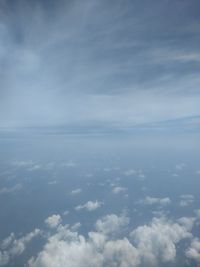 Aerial view of clouds over sea against sky