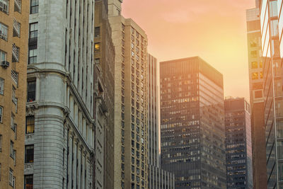 Low angle view of modern buildings in city against sky