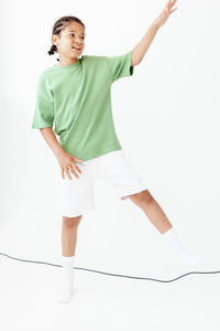 Low section of woman standing against white background