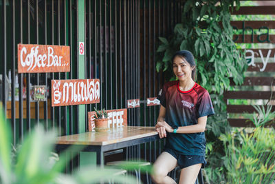 Full length of a smiling young woman in restaurant