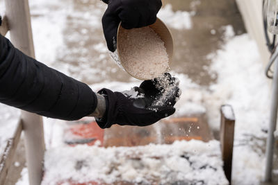 Close-up of person working on snow