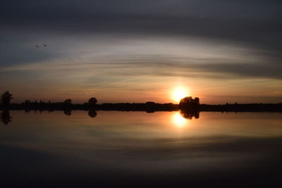 Scenic view of lake against sky during sunset