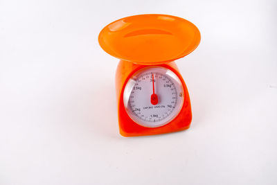 Close-up of weight scale over white background