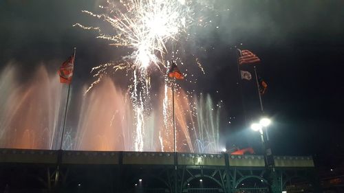 Low angle view of firework display at night