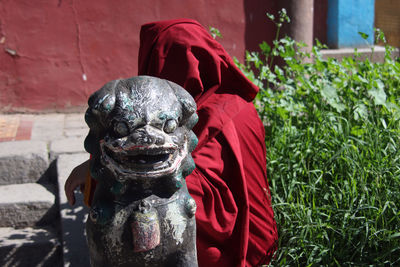 Close-up of statue against red wall