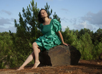 Portrait of beautiful young woman against sky