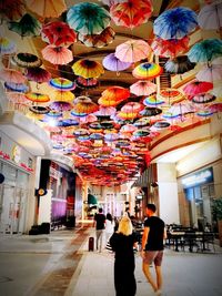 Rear view of people walking in multi colored building