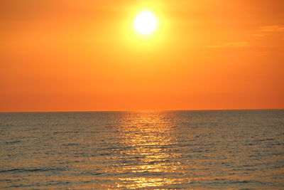 Scenic view of sea against orange sky