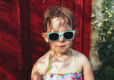 Portrait of a child in sunglasses and a bathing suit. summer is a time of pleasure and fun. 