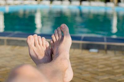 Midsection of man swimming in pool