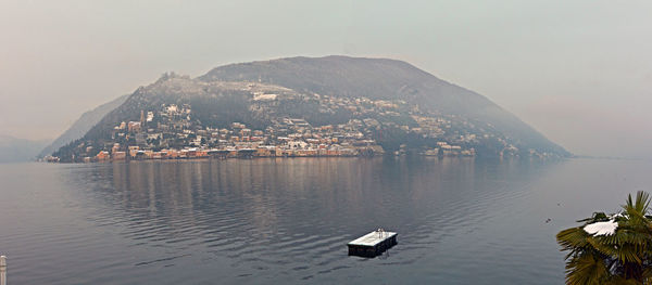 Scenic view of lake and mountains against clear sky