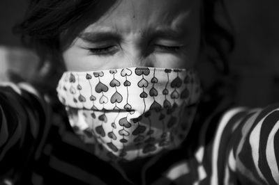 Close-up portrait of little girl with medical mask