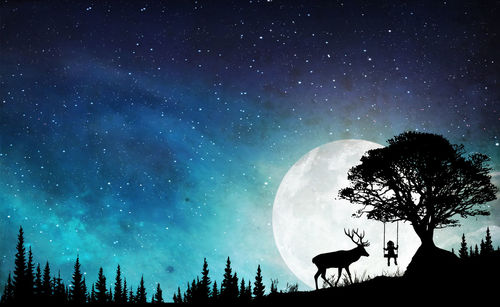 Low angle view of silhouette trees against sky at night