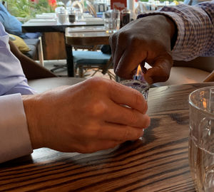 Midsection of man having food at table