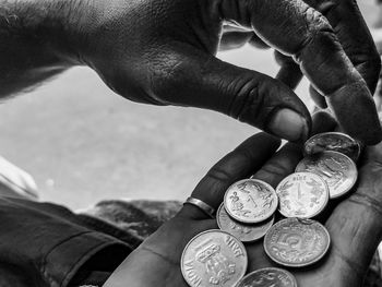 Close-up of hand holding coins