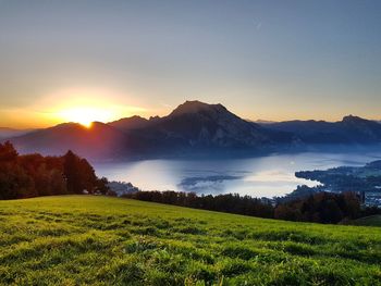 Scenic view of field against sky during sunset