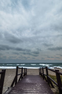 Pier over sea against sky