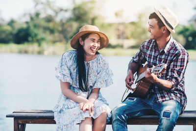 Young couple sitting outdoors