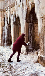 Full length side view of woman standing in cave